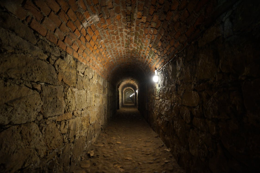 Narrow underground stone passage showing real secret passages in historic buildings