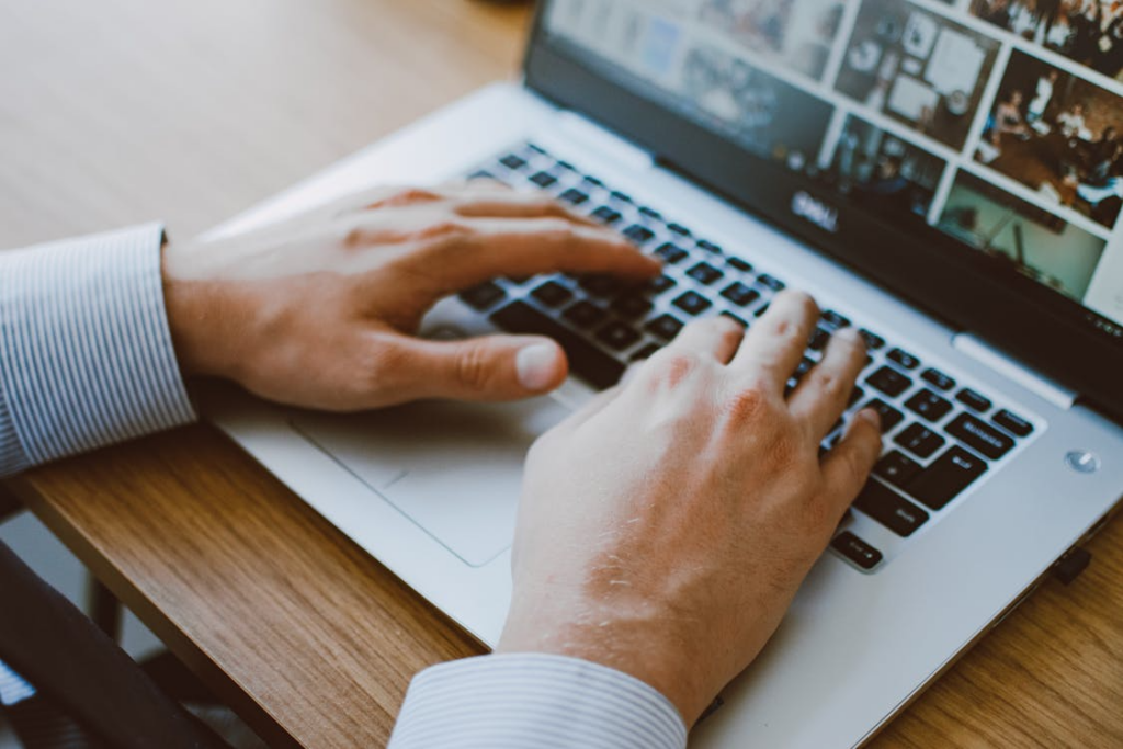 Person browsing historical images on a laptop showing online archives to explore from home