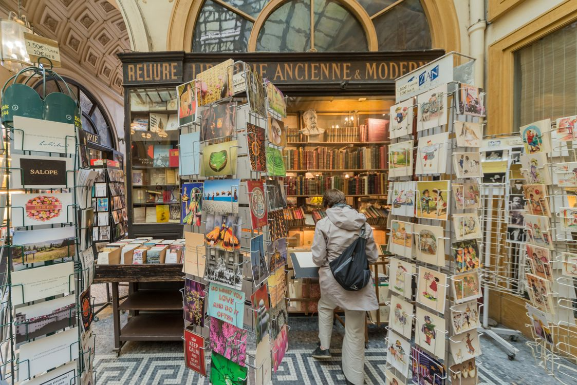 Historic bookstore entrance with postcards and old books as an example of unusual bookstores to visit