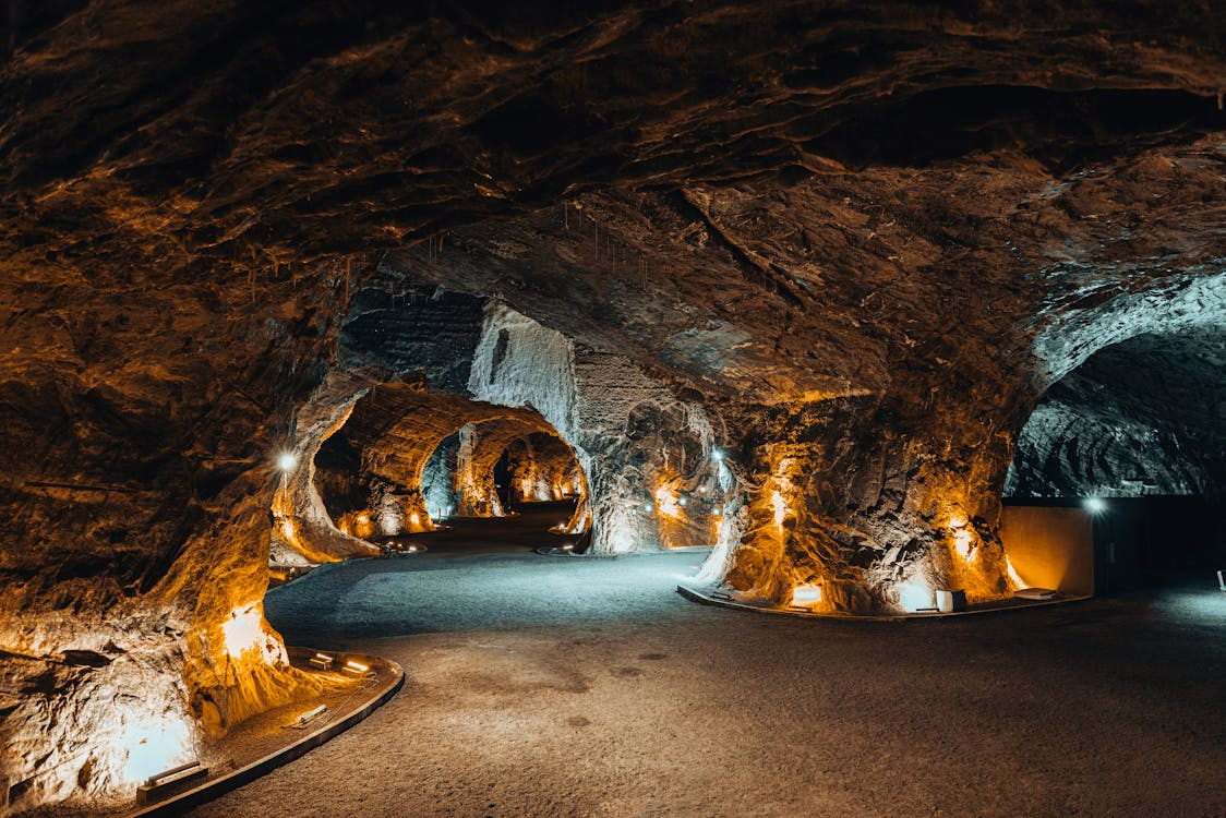 Illuminated underground cave passage showing underground attractions to visit beneath the surface