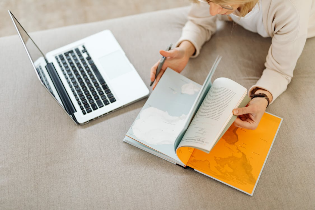 Reader using a laptop and book showing educational internet rabbit holes for curiosity-led learning