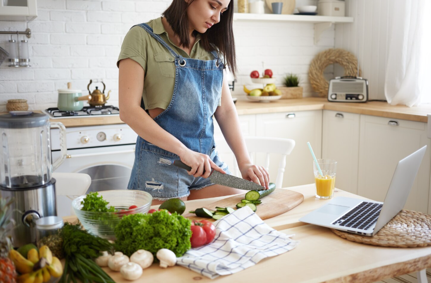 Woman following a cooking lesson on a laptop showing skills to learn in a weekend